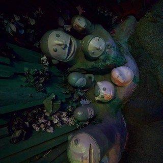 Whimsical Snowman Family Display in Atmospheric Lighting