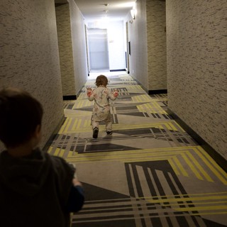 Children Playing in Modern Hotel Corridor at Dusk