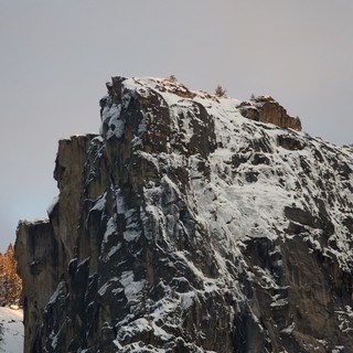 Snow-Covered Rock Pinnacle in Winter Mountain Forest
