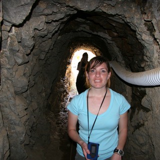 Explorer Poses Inside Ancient Rock Mine Tunnel
