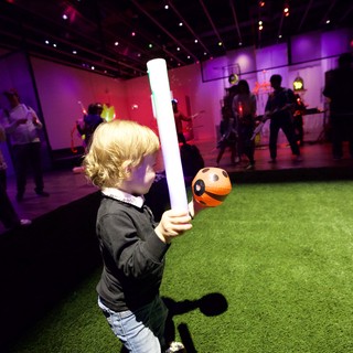 Child with Lightsaber at Baby Rave Event