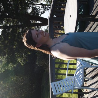 Joyful Woman Relaxing on Sunlit Outdoor Deck
