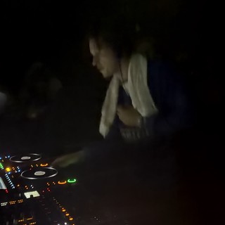 DJ at Work Behind Illuminated CDJ Decks in London