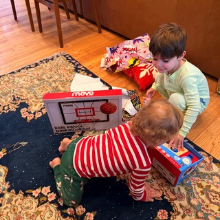 Children Opening Christmas Presents on Living Room Floor