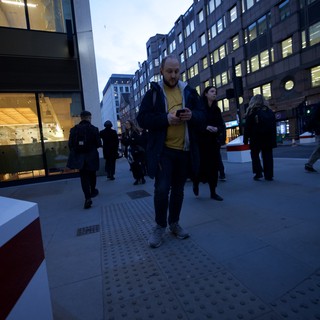 Urban Commuters on Modern London Street at Dusk