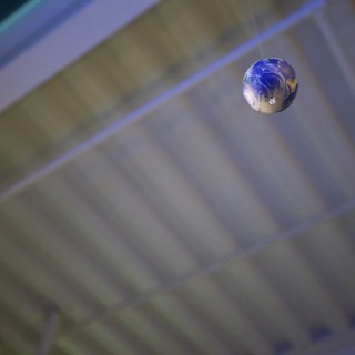 Earth Marble Suspended in Cosmic Blur