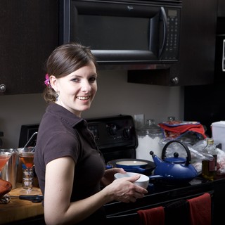 Smiling Woman Cooking in a Cozy Home Kitchen