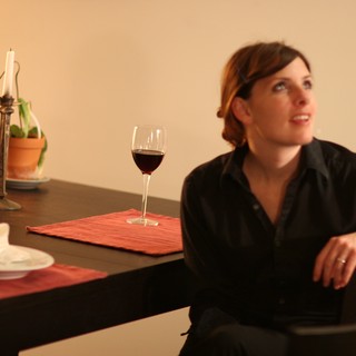 Woman in Black Contemplating Over Evening Wine