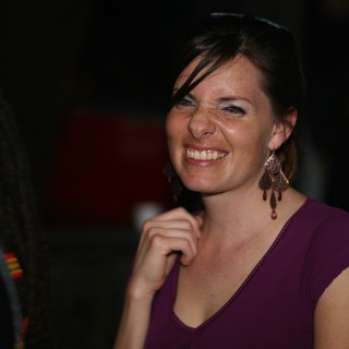 Radiant Smile at a Nighttime Social Gathering