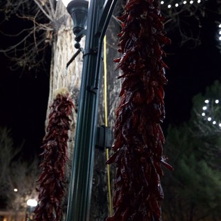 Red Chile Ristras Hanging from Lamppost at Night