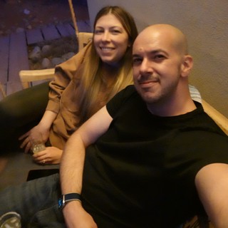 Couple Relaxing on Suspended Wooden Swing