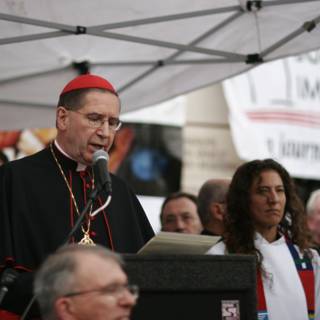 Bishop Roger Mahony Addresses Rally with Microphone