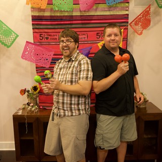Two Friends Celebrate with Maracas at Fiesta Party