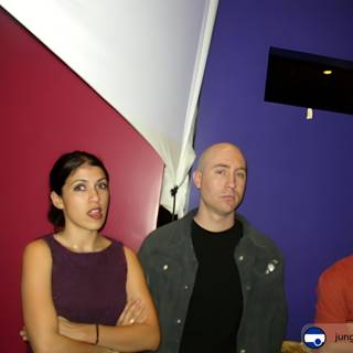 Three People In Front of a Purple Wall