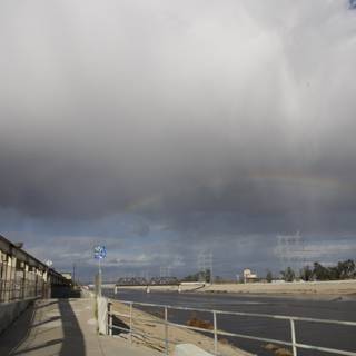 Vibrant Rainbow over the Roadway