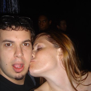 Spontaneous Kiss at a Crowded Nightclub Party