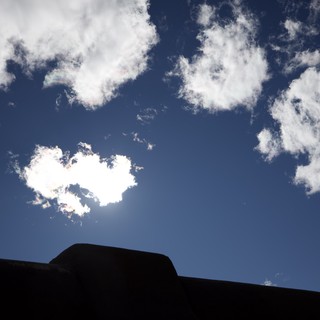 Silhouetted Adobe Architecture Against Bright Blue Sky