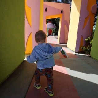 Child Exploring Colorful Architectural Play Structure