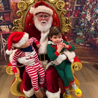 Two Children Visit Santa in His Ornate Christmas Throne