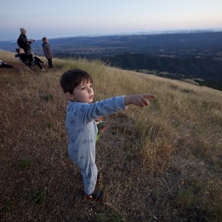 Young Explorer Points Toward the Valley Below