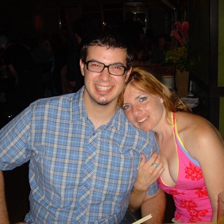 Couple Smiling Together at a Dimly Lit Restaurant