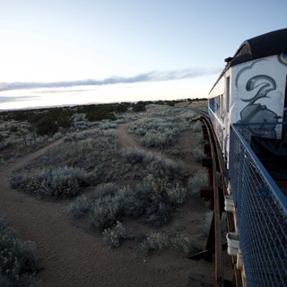 Sunset Train Journey Through Desert Landscape