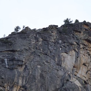 Dramatic Layered Rock Face with Overhanging Cliff Edge