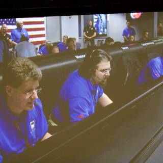 Blue Shirted Men Working on Computer