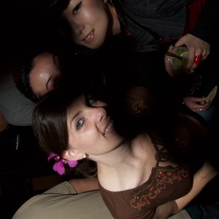 Friends Leaning In at a Nightclub Art Walk
