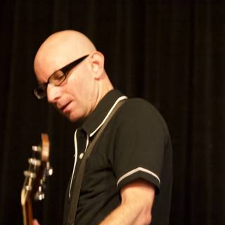 Bald Man with Glasses Shreds on Guitar