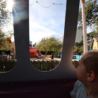 Child's Wonder: Peering Through Playground Windows