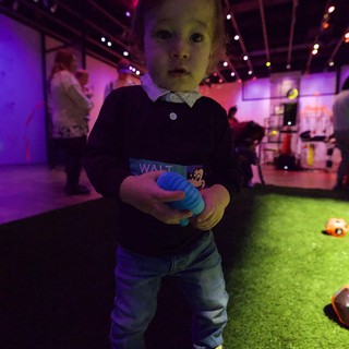 Toddler at Baby Rave Event Under Colorful Lights