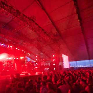 Red Spotlight on A Rock Concert Crowd