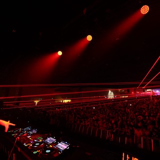 DJ Commands Massive Crowd Under Red Laser Storm