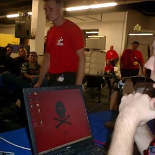 Man in Red Shirt Working on Laptop