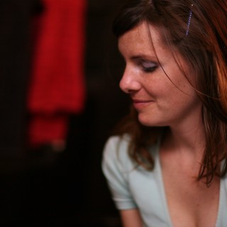 Pensive Woman in Soft Light at Evening Venue