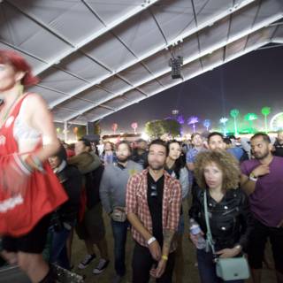 Nighttime Crowd Under Tent at Coachella Festival