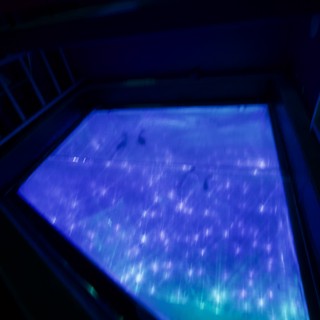 Ethereal Blue Light Installation in Darkened Gallery