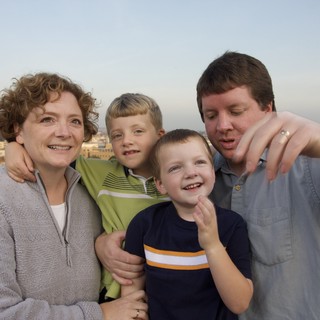 Family Rooftop Portrait at City Sunset