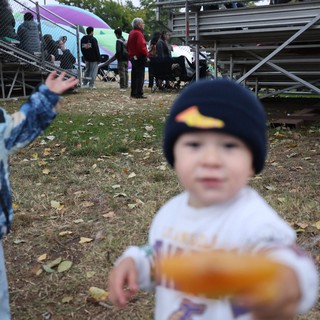 Toddler Offers Snack at Hot Air Balloon Festival