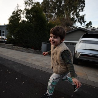 Joyful Child Playing in Suburban Driveway at Dusk