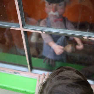 Child's Wonder Through Window at Fantasyland Display