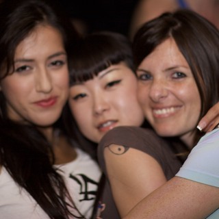 Three Friends Embrace at a Nightclub in 2006