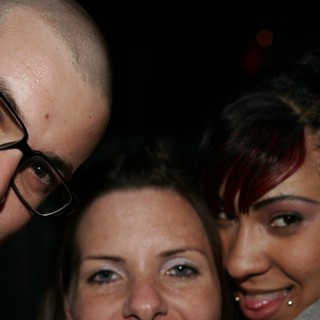 Three Friends Posing Together at a Nighttime Event