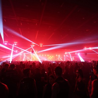 Massive Crowd Ignites Under Red Light Storm
