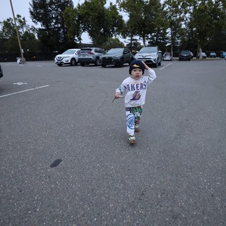 Toddler Runs Free in Parking Lot at Balloon Festival