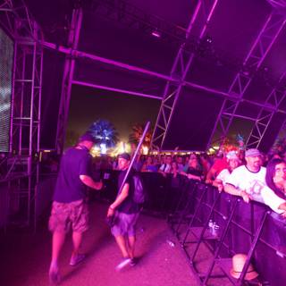Partygoers Enjoying a Concert at Coachella with Large Screen