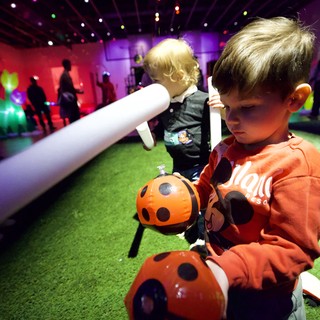 Children Engaging with Ladybug Robot at Baby Rave Event