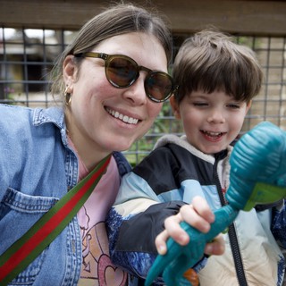 Joyful Mother and Son with Toy Dinosaurs