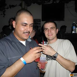 Two Men Enjoying Drinks at Nightclub